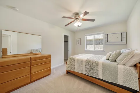 a bedroom with a bed and window