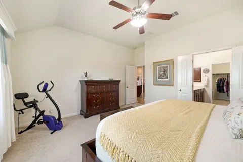 a bed room with a bed and a flat tv screen