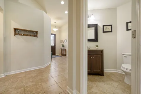 a view of a hallway with bathroom and a bathroom