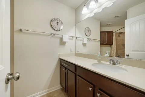 a bathroom with a sink vanity and a mirror