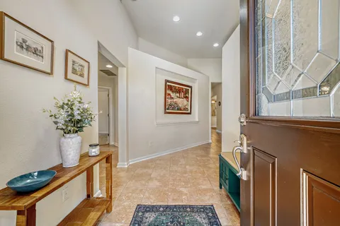 a view of an entryway with wooden floor and a potted plant