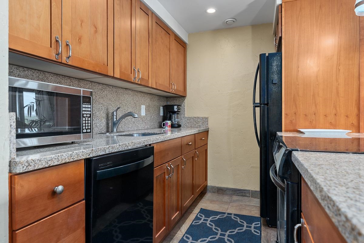 73 North Kihei Road, Unit 602 Kihei, HI 96753 - Photo 11 of 47 a kitchen with stainless steel appliances granite countertop a sink stove and refrigerator