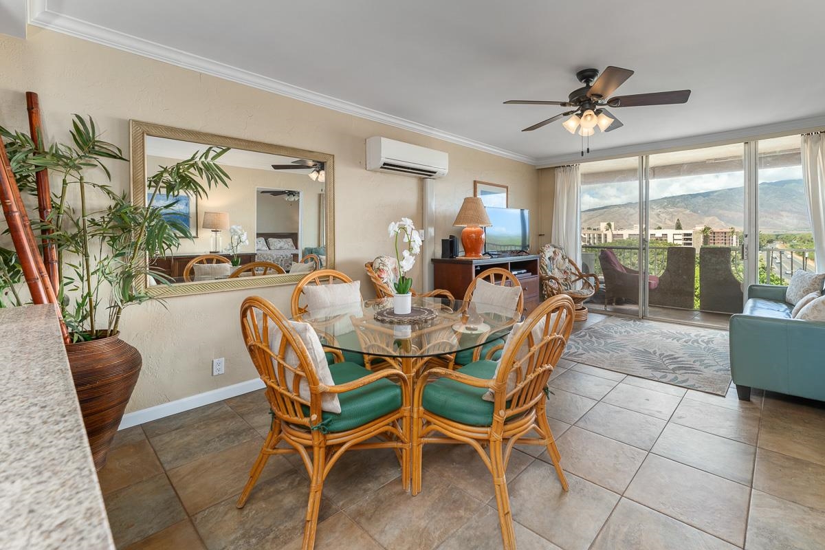 73 North Kihei Road, Unit 602 Kihei, HI 96753 - Photo 12 of 47 a dining room with furniture a chandelier and window