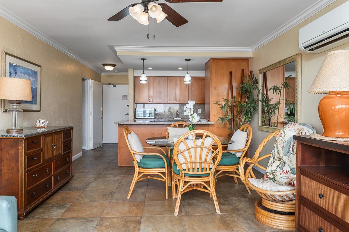 73 North Kihei Road, Unit 602 Kihei, HI 96753 - Photo 20 of 47 a dining area with a table chairs and a kitchen view