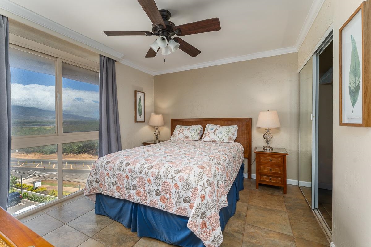 73 North Kihei Road, Unit 602 Kihei, HI 96753 - Photo 25 of 47 a bedroom with a bed and a chandelier