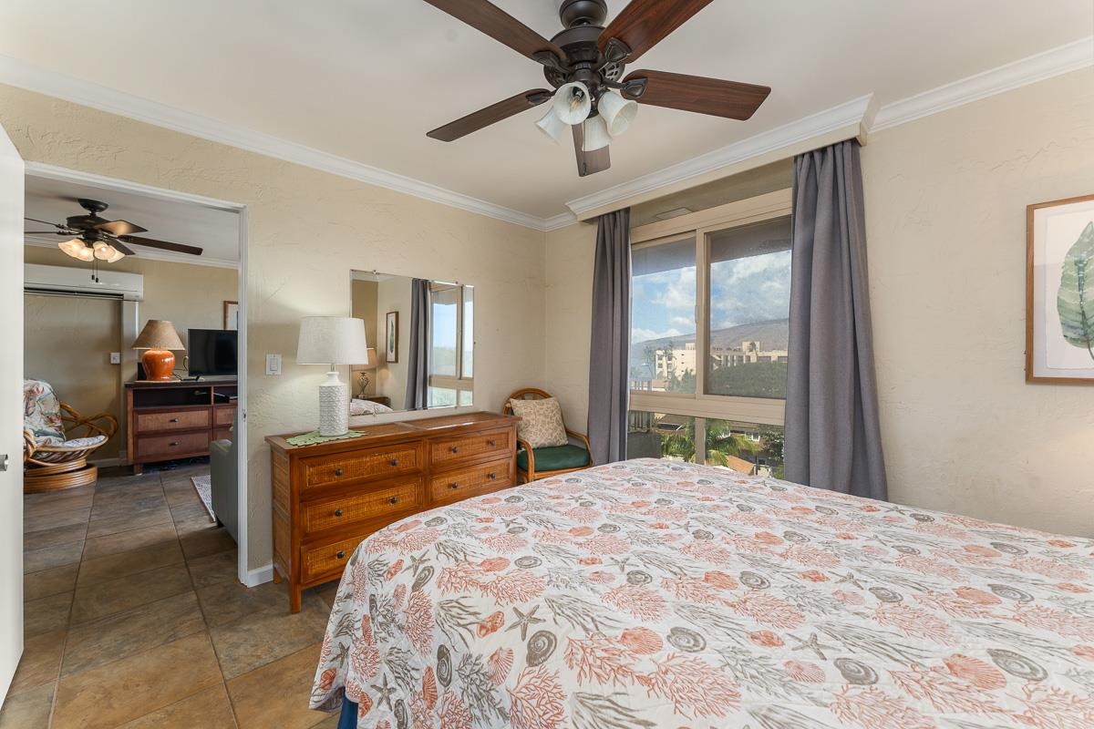 73 North Kihei Road, Unit 602 Kihei, HI 96753 - Photo 26 of 47 a bedroom with a large bed and a chandelier