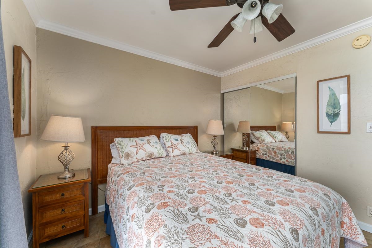 73 North Kihei Road, Unit 602 Kihei, HI 96753 - Photo 27 of 47 a bedroom with a bed and wooden floor