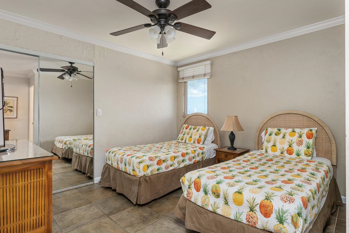 73 North Kihei Road, Unit 602 Kihei, HI 96753 - Photo 34 of 47 a bedroom with two beds and ceiling fan