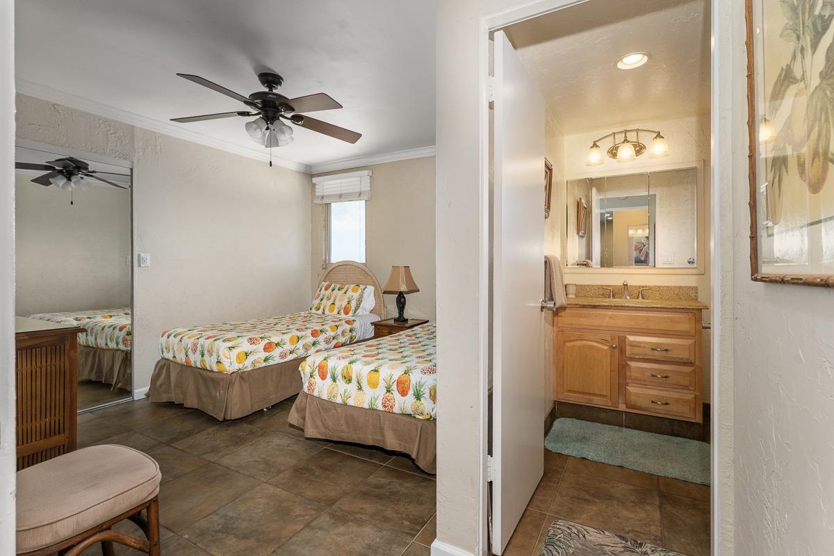 73 North Kihei Road, Unit 602 Kihei, HI 96753 - Photo 36 of 47 a bedroom with a bed and a chandelier
