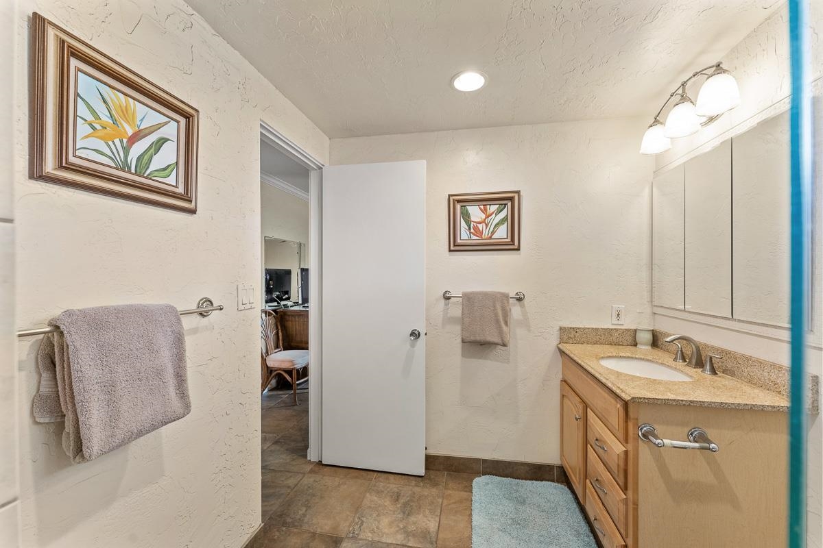 73 North Kihei Road, Unit 602 Kihei, HI 96753 - Photo 38 of 47 a bathroom with a sink and a mirror