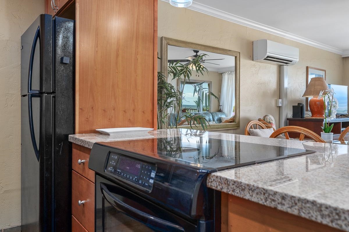 73 North Kihei Road, Unit 602 Kihei, HI 96753 - Photo 6 of 47 a kitchen with granite countertop a sink a stove and refrigerator