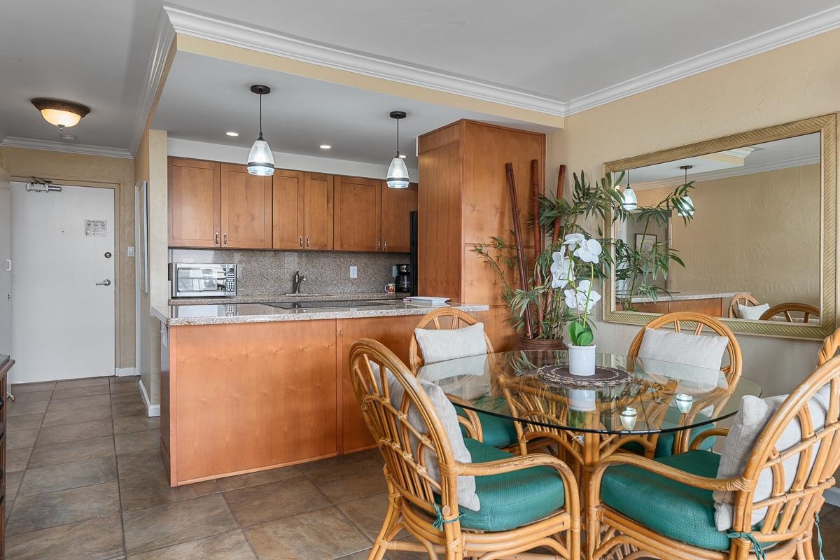 73 North Kihei Road, Unit 602 Kihei, HI 96753 - Photo 7 of 47 a dining room filled with furniture and a chandelier