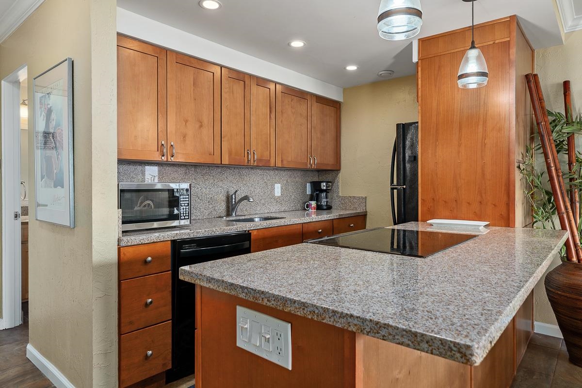 73 North Kihei Road, Unit 602 Kihei, HI 96753 - Photo 10 of 47 a kitchen with stainless steel appliances granite countertop a sink a refrigerator and a stove