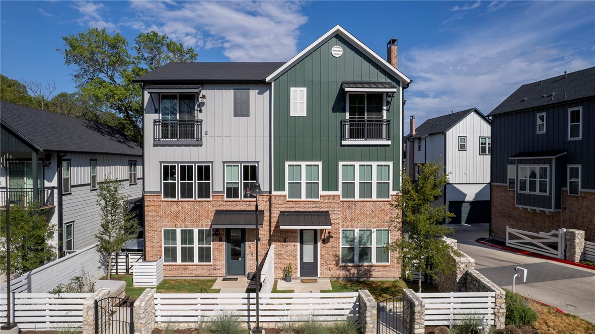 a front view of a residential apartment building with a yard