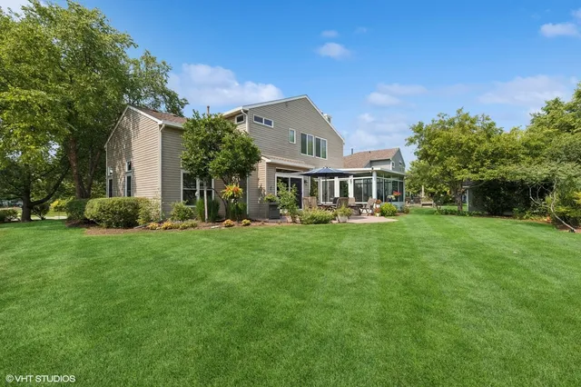 a view of a house with a yard and sitting area