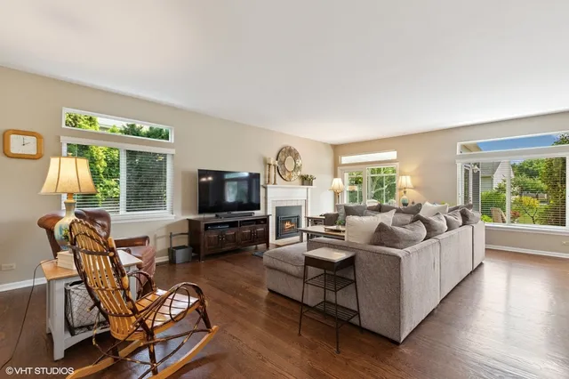 a living room with furniture flat screen tv and a large window