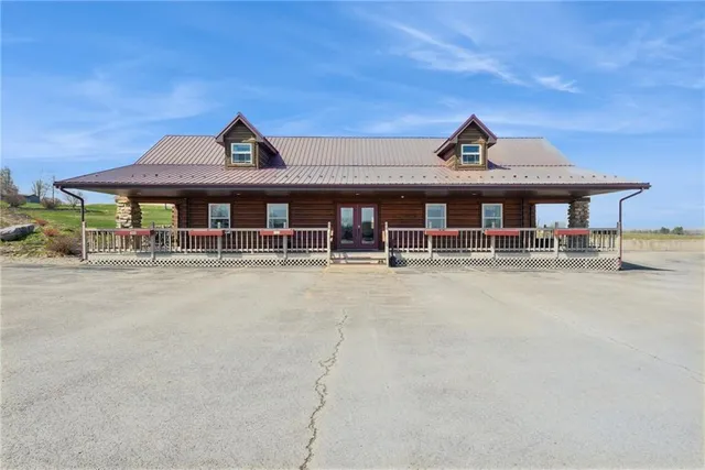 a view of a house with large windows and a table