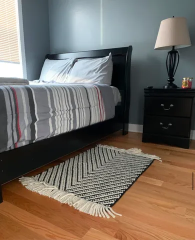 a bedroom with a bed and a window