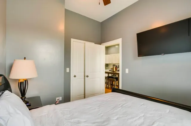 a bedroom with a bed and a flat screen tv