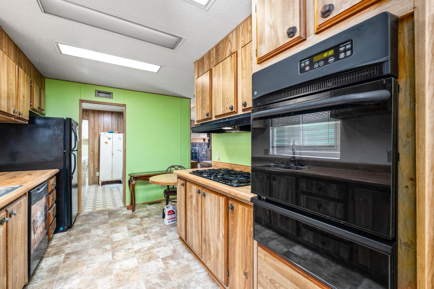 1200 South Carpenter Road, Unit 4 Modesto, CA 95351 - Photo 12 of 31 Kitchen featuring wood-finish cabinetry, black built-in double oven, and an integrated gas cooktop. No refrigerator