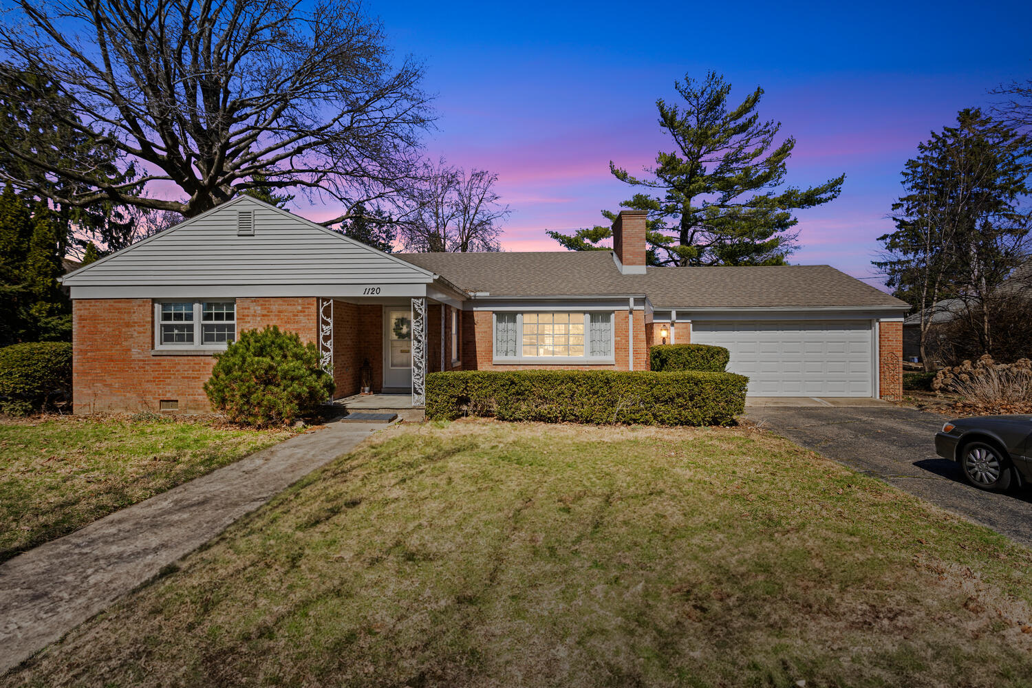1120 West Charles Street Champaign, IL 61821 - Photo 1 of 36 a front view of a house with a garden