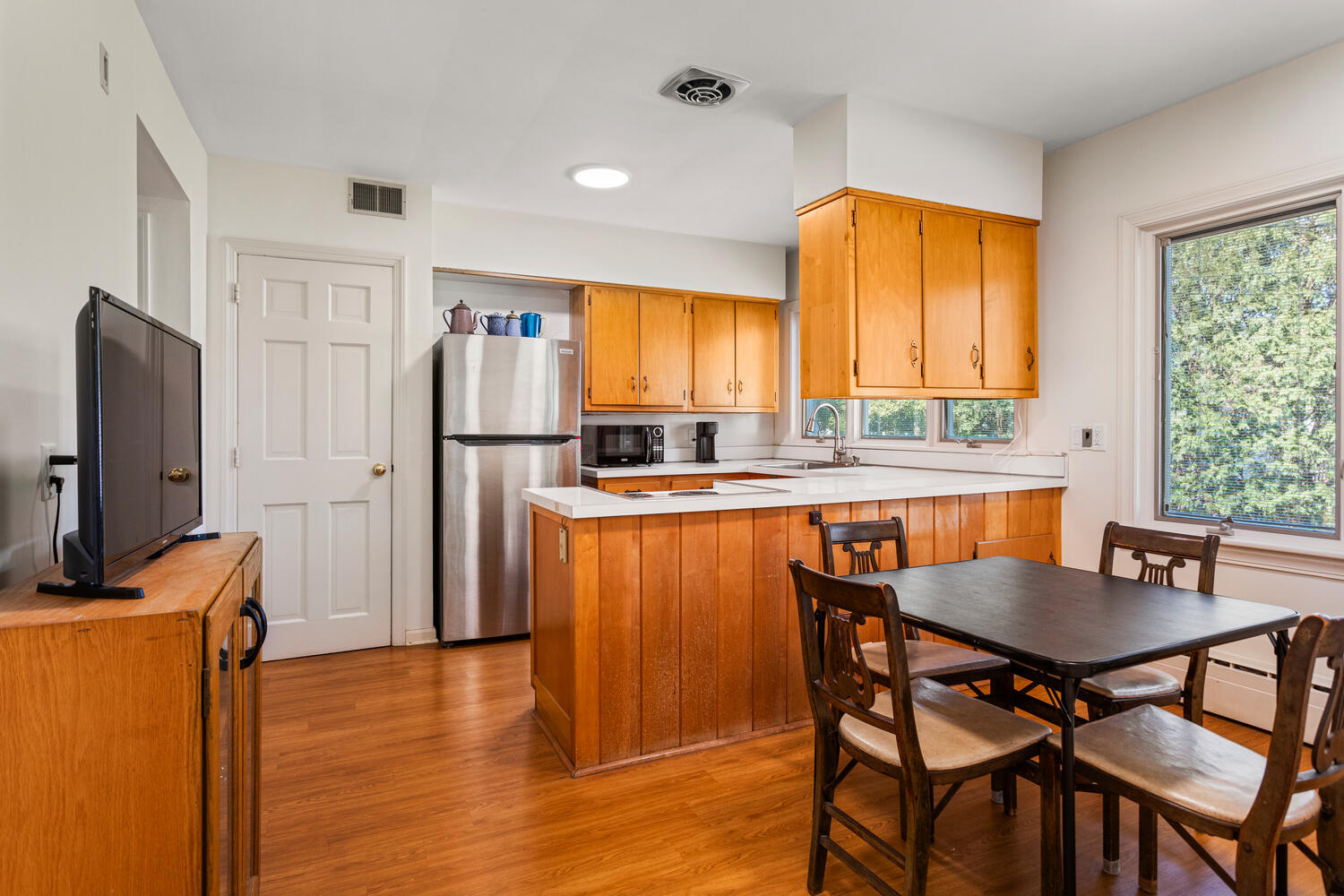 1120 West Charles Street Champaign, IL 61821 - Photo 16 of 36 a kitchen with stainless steel appliances granite countertop a stove a refrigerator a sink a dining table and chairs