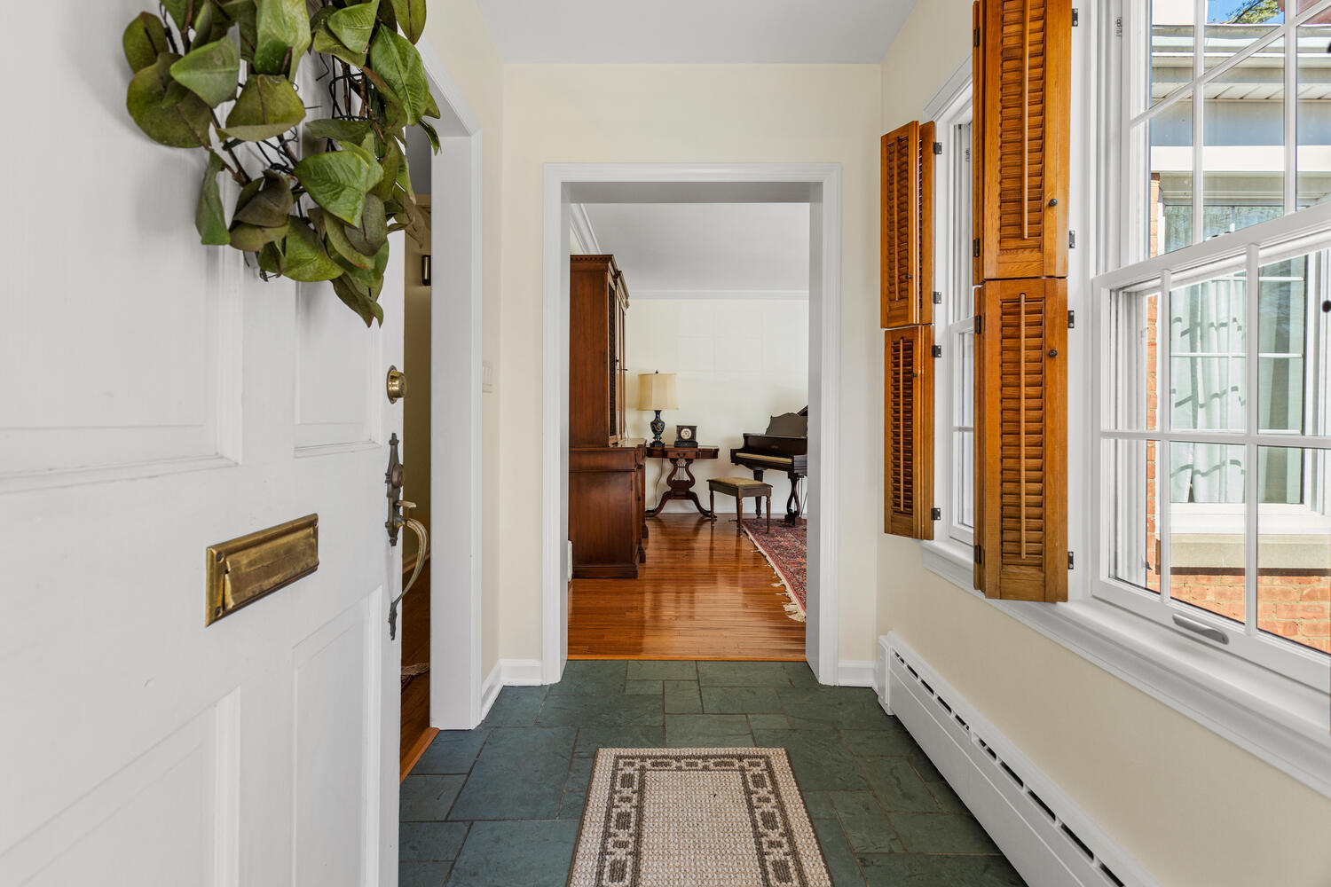 1120 West Charles Street Champaign, IL 61821 - Photo 5 of 36 a hallway with wooden floor and a potted plant