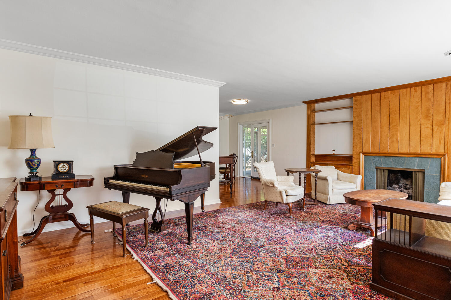 1120 West Charles Street Champaign, IL 61821 - Photo 6 of 36 a living room with furniture a piano and a fireplace