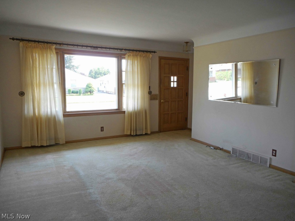 12311 Orme Road Garfield Heights, OH 44125 - Photo 2 of 12 Spacious Living Room with Carpet over Wood Floor.