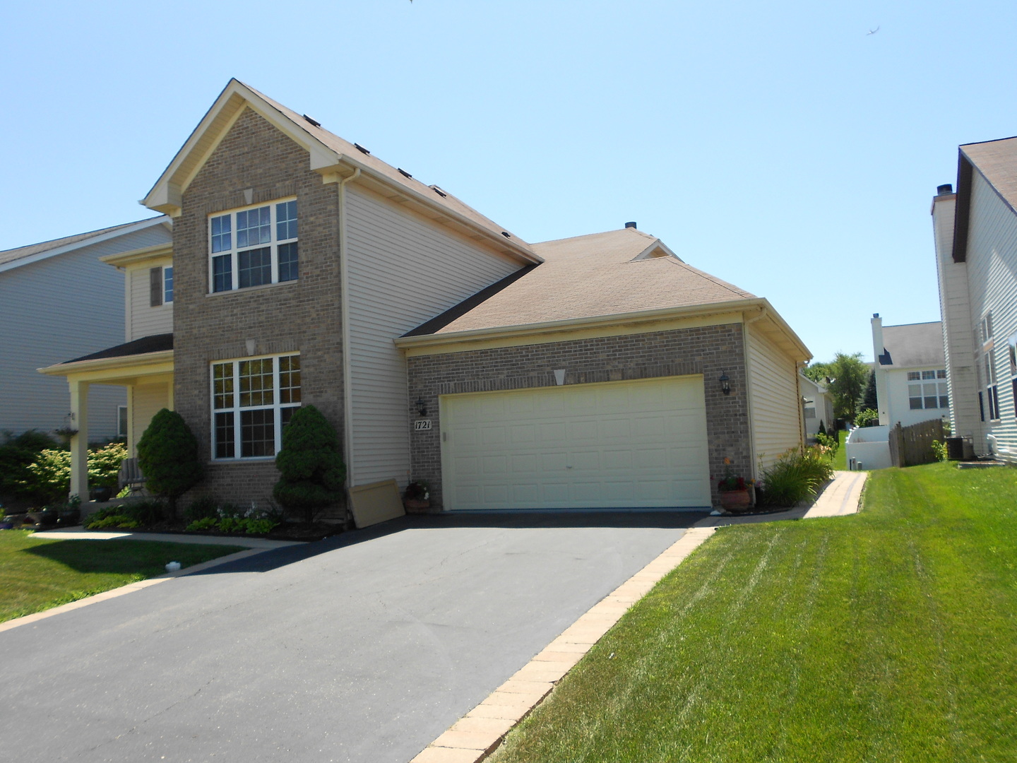 1721 Pin Oak Lane Elgin, IL 60120 - Photo 7 of 39 a front view of a house with a yard and garage