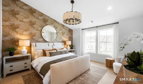 a bedroom with bed and a large window