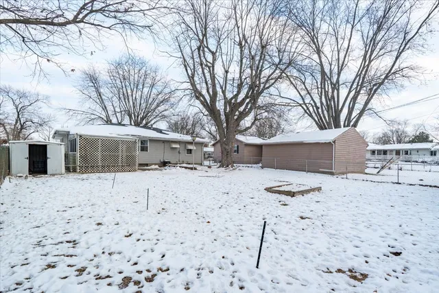 a view of a house with a snow on the road