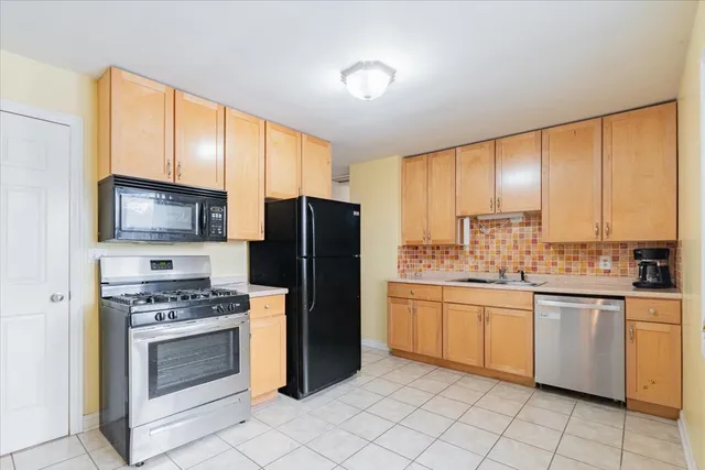 a kitchen with stainless steel appliances a stove sink and microwave