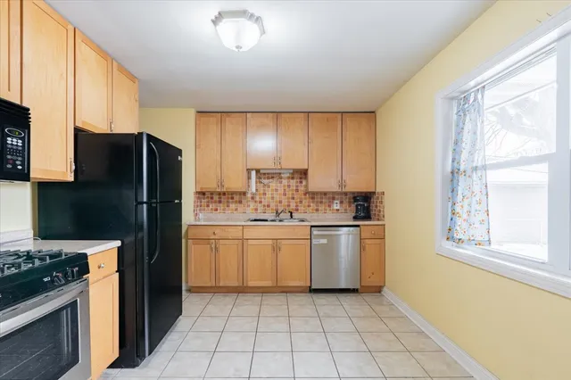a kitchen with a refrigerator sink and stove