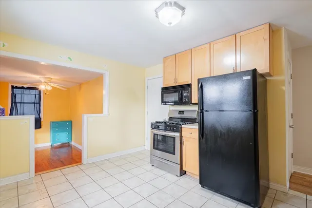 a kitchen with stainless steel appliances granite countertop a refrigerator and a stove