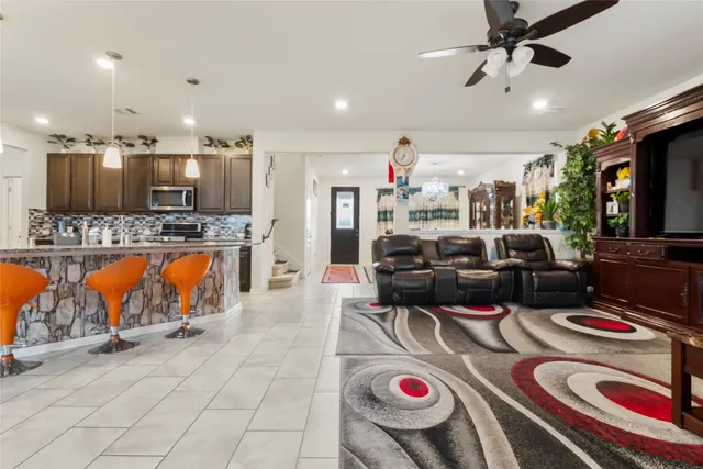 a living room with lots of furniture and kitchen view