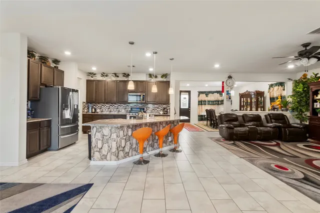 a large kitchen with stainless steel appliances lots of counter space and a sink