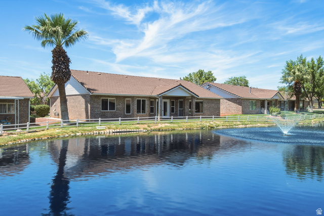 805 South River Road, Unit 70 St. George, UT 84790 - Photo 1 of 38 Brick exterior residential building featuring a tile roof, multiple windows, and an outdoor patio with a covered section