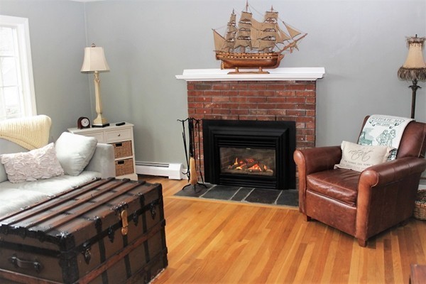 9 Shadwell Road Scituate, MA 02066 - Photo 5 of 24 a living room with furniture and a fireplace