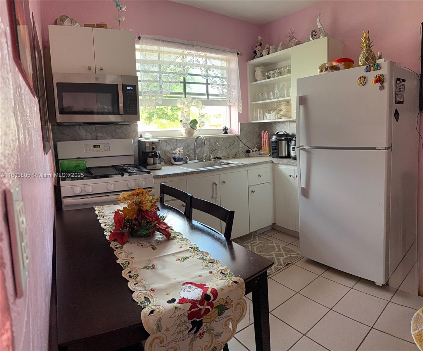102 West 27th Street Hialeah, FL 33010 - Photo 15 of 26 a kitchen with stainless steel appliances granite countertop a refrigerator sink stove and microwave