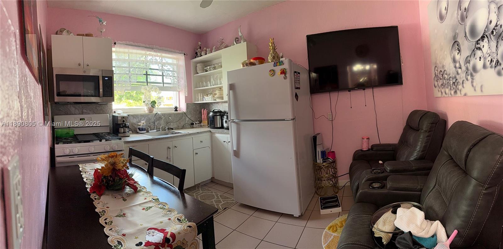 102 West 27th Street Hialeah, FL 33010 - Photo 16 of 26 a living room with furniture and a flat screen tv