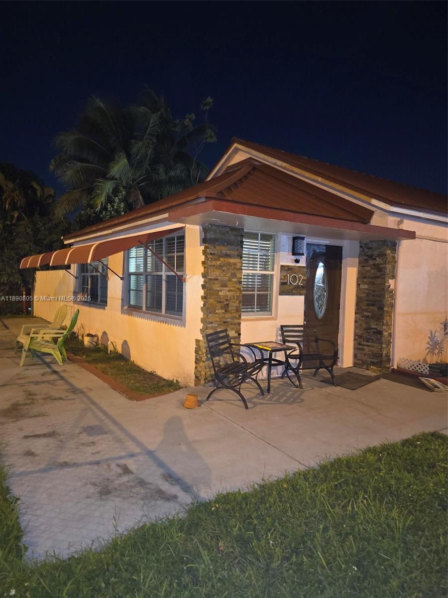 102 West 27th Street Hialeah, FL 33010 - Photo 2 of 26 a view of a house with backyard sitting area and garden