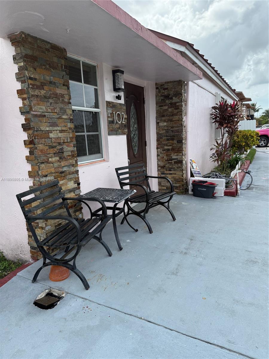 102 West 27th Street Hialeah, FL 33010 - Photo 3 of 26 a view of a patio with table and chairs