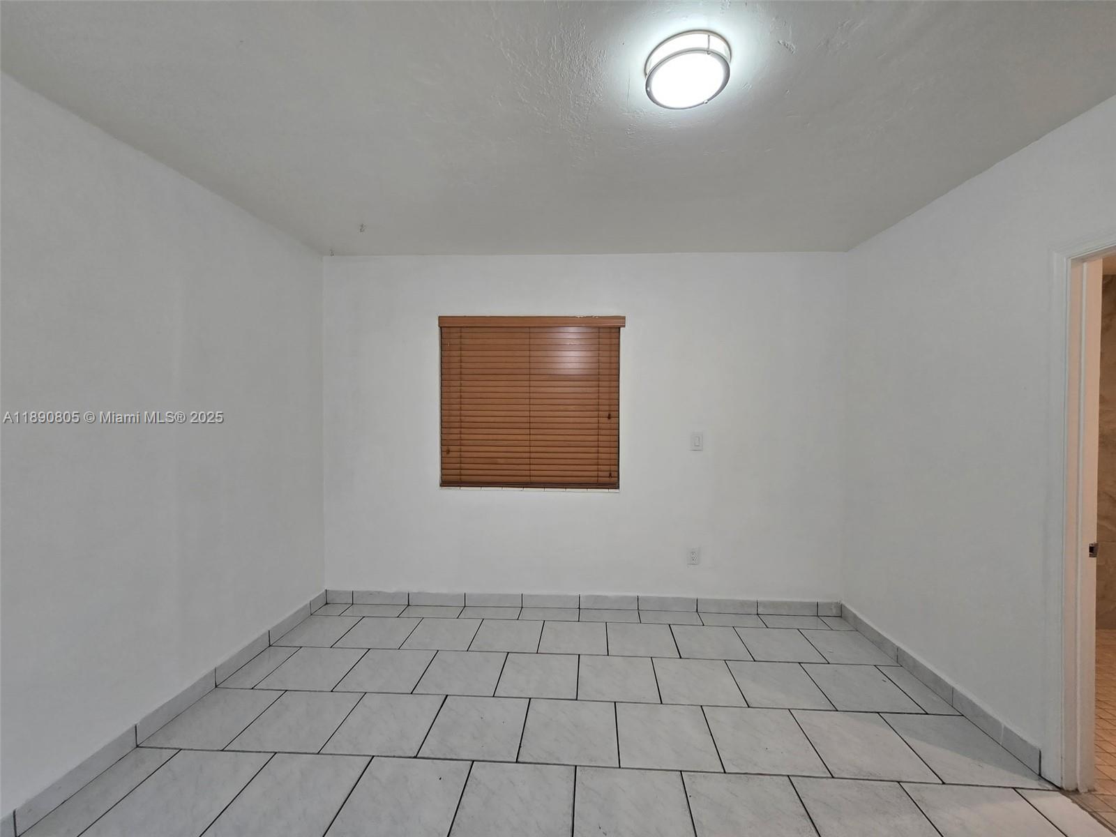 102 West 27th Street Hialeah, FL 33010 - Photo 8 of 26 a view of an empty room