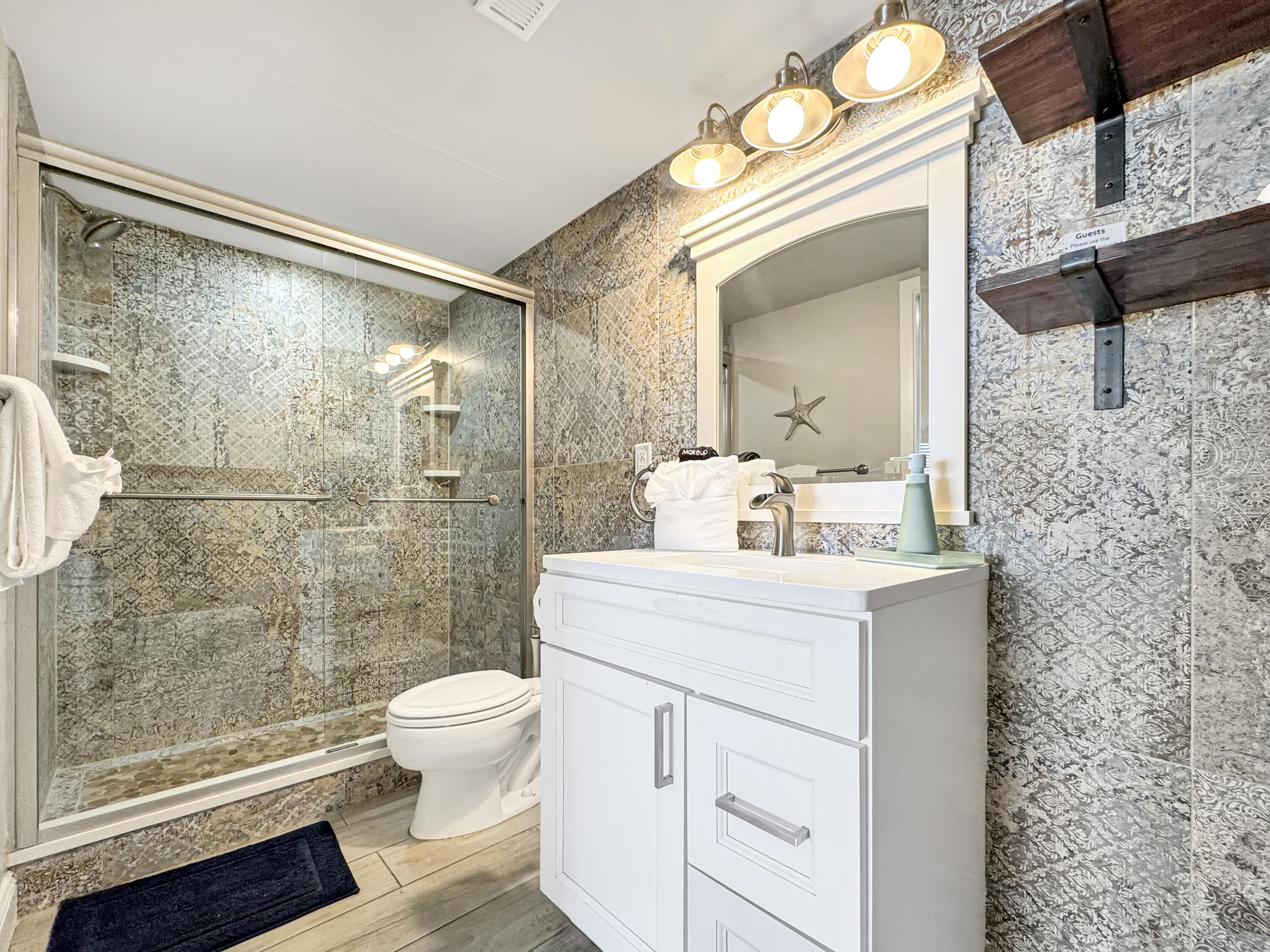 14401 Front Beach Road, Unit 221 Panama City Beach, FL 32413 - Photo 11 of 20 a bathroom with a sink a toilet and shower