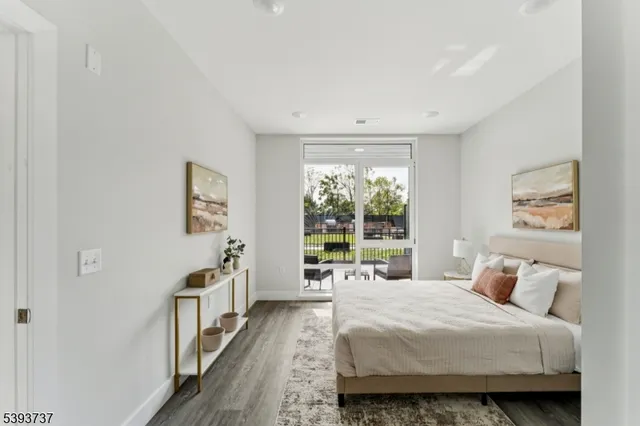 a bedroom with a bed and a large window