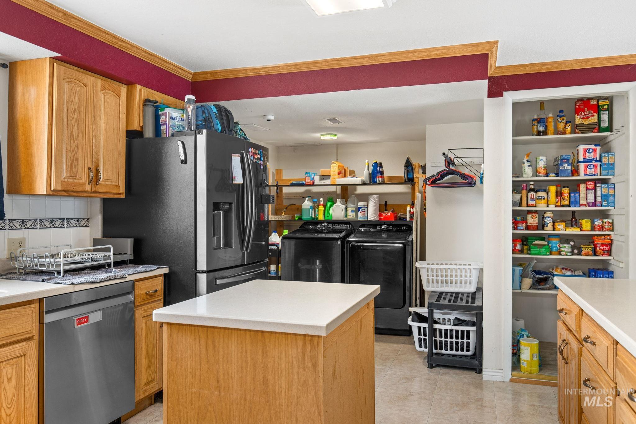 18338 Pride Lane Caldwell, ID 83607 - Photo 14 of 50 Kitchen with light wood cabinetry, white countertops, and a stainless steel dishwasher