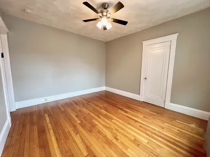 a view of an empty room and wooden floor