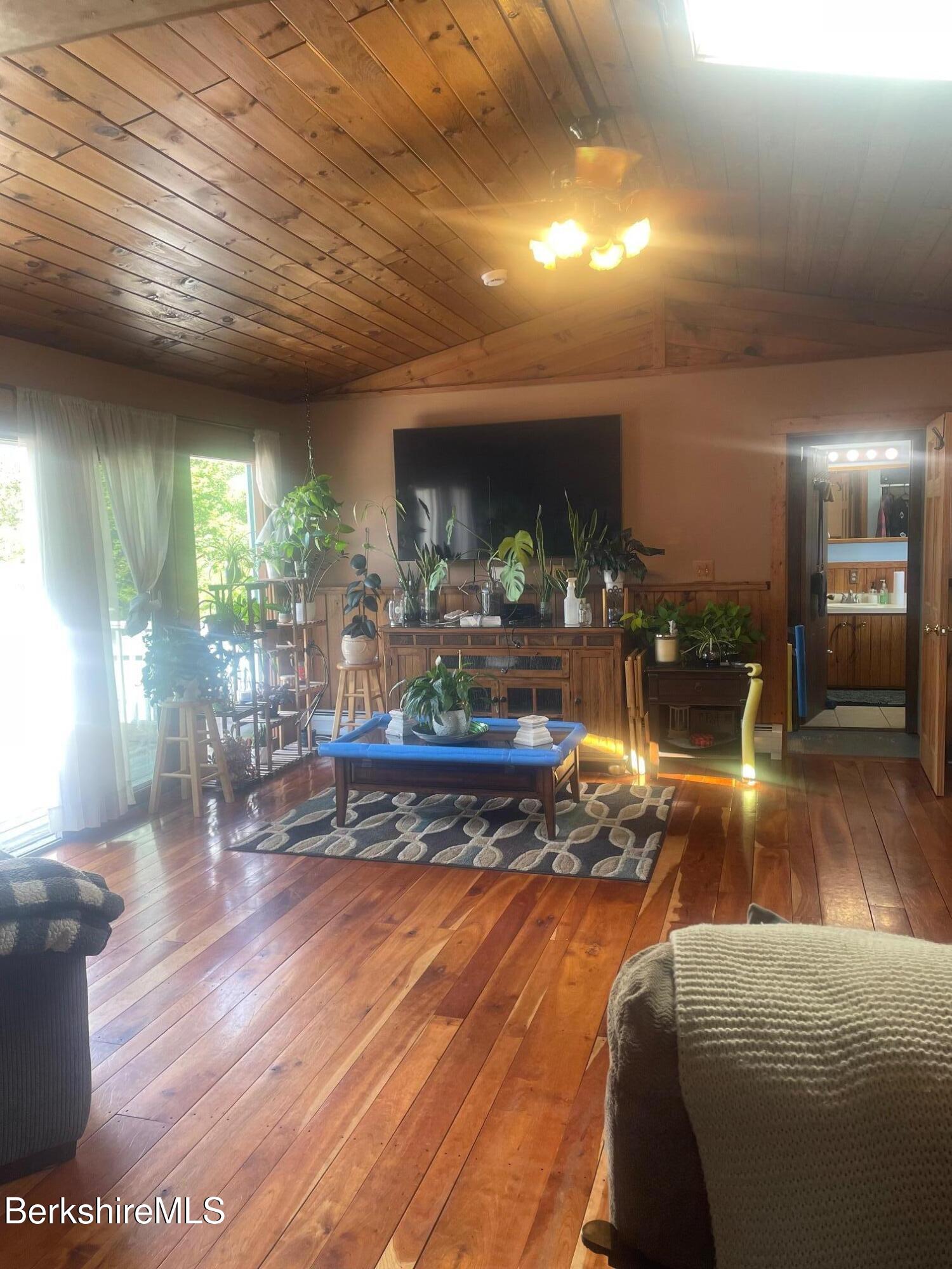 554 Main Street Becket, MA 01223 - Photo 14 of 36 a living room with furniture and a wooden floor
