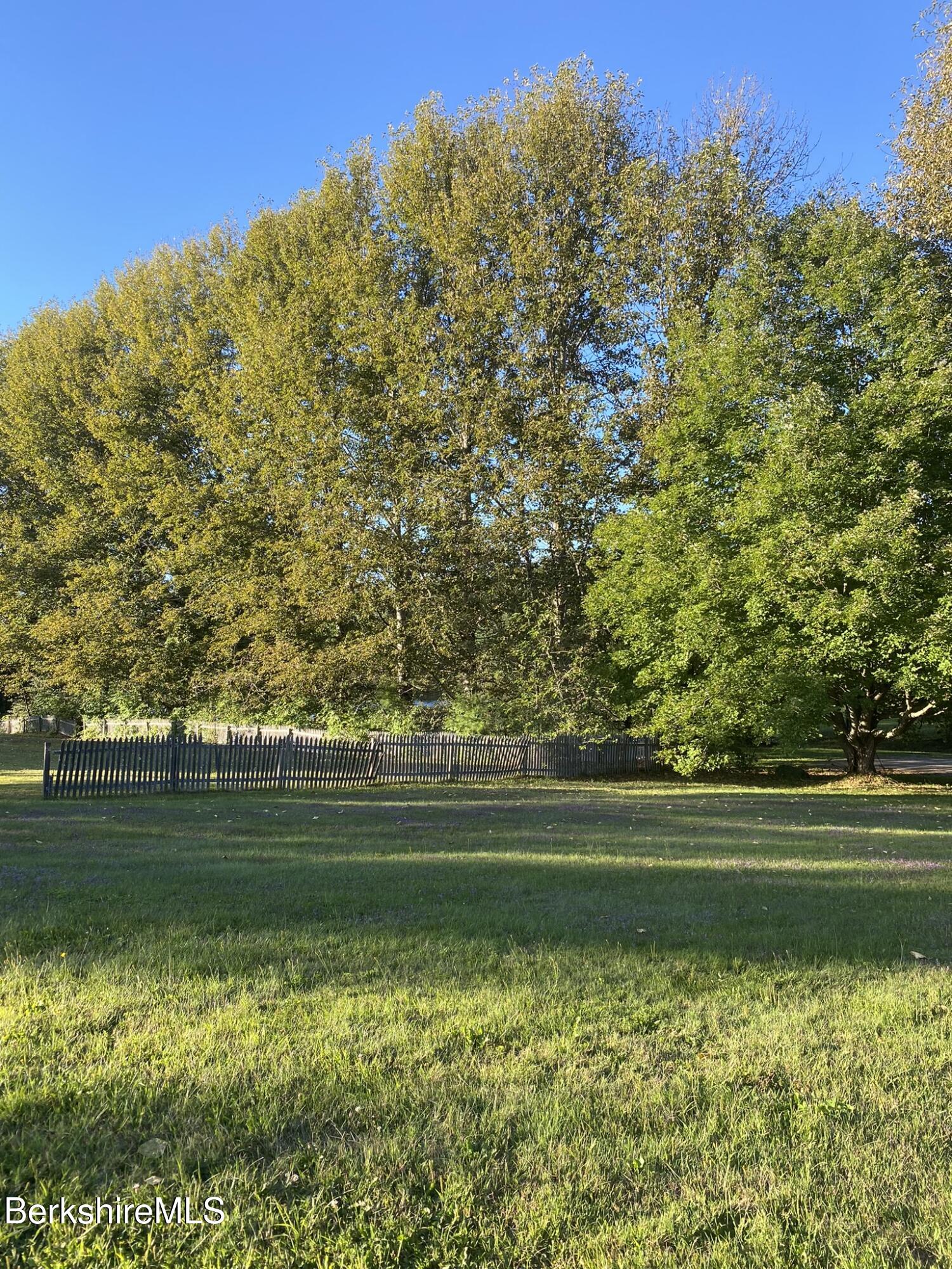 554 Main Street Becket, MA 01223 - Photo 23 of 36 a view of a golf course with a lake